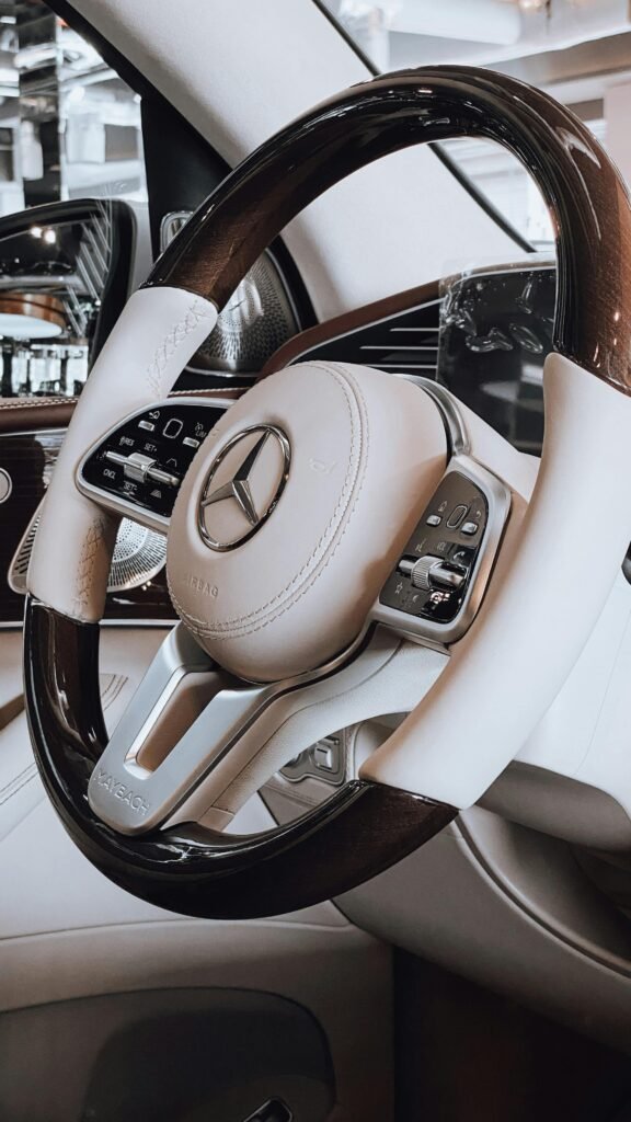 Close-up of a luxury Mercedes Benz steering wheel, showcasing elegance and design.